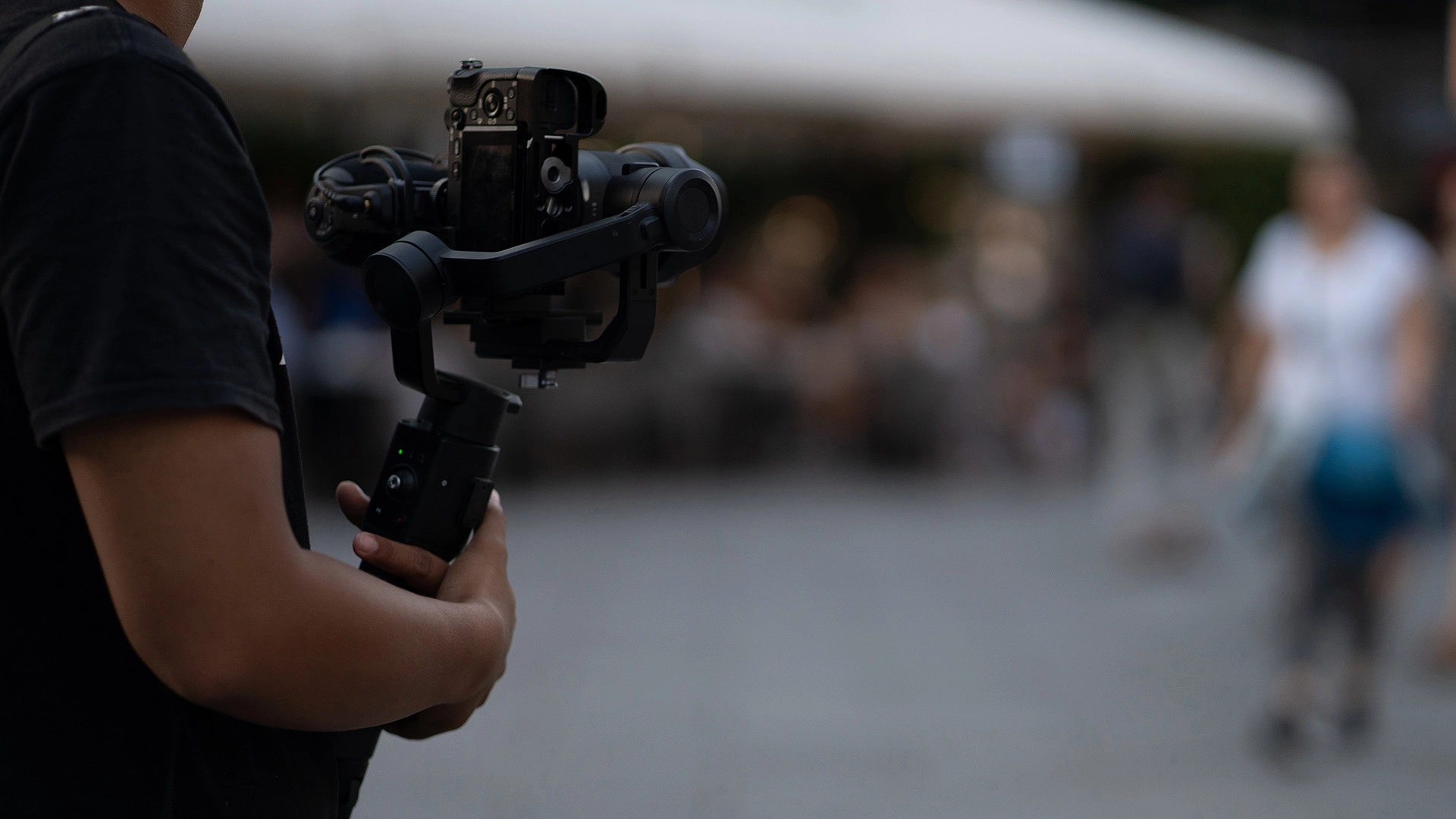 Person videoing with a camera on a gimbal