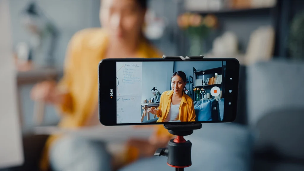 Asia lady filming video content on mobile phone