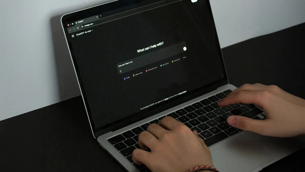 Person using ChatGPT on a laptop