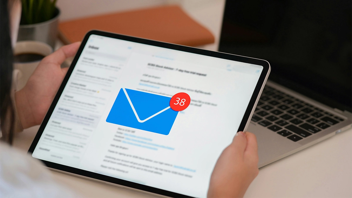 Lady holding an ipad with new email message