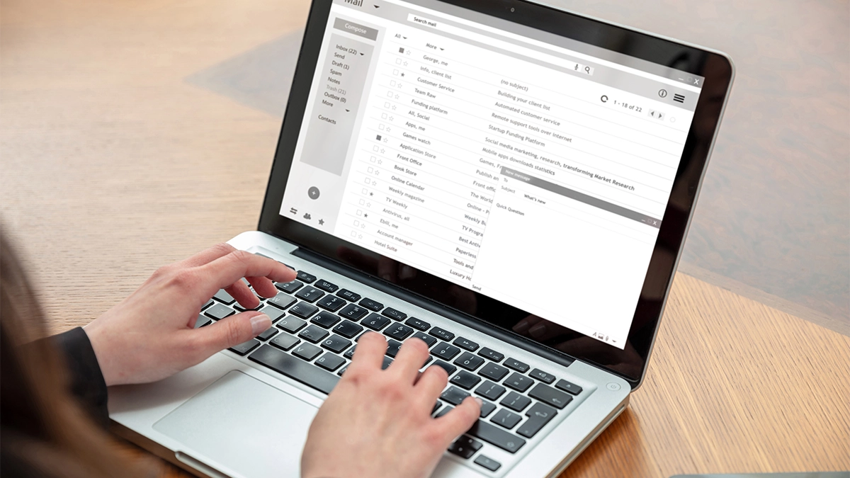Woman looking at emails on laptop