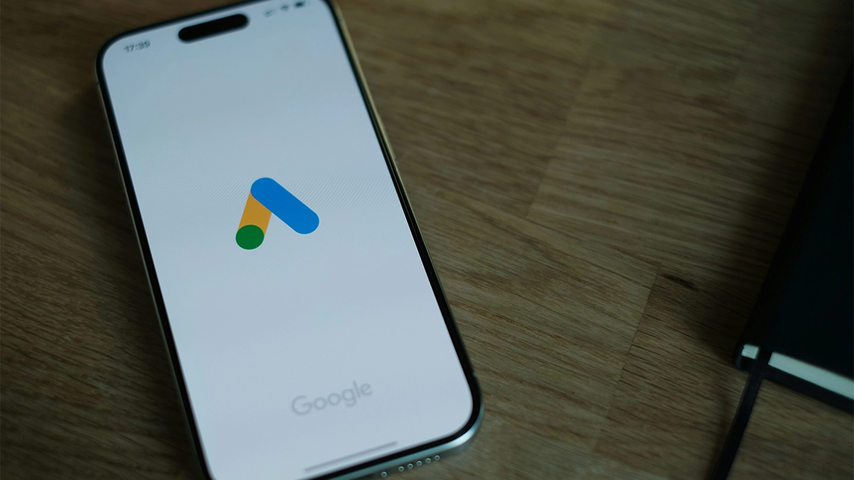 A close up of a cell phone with Google Ads on a table