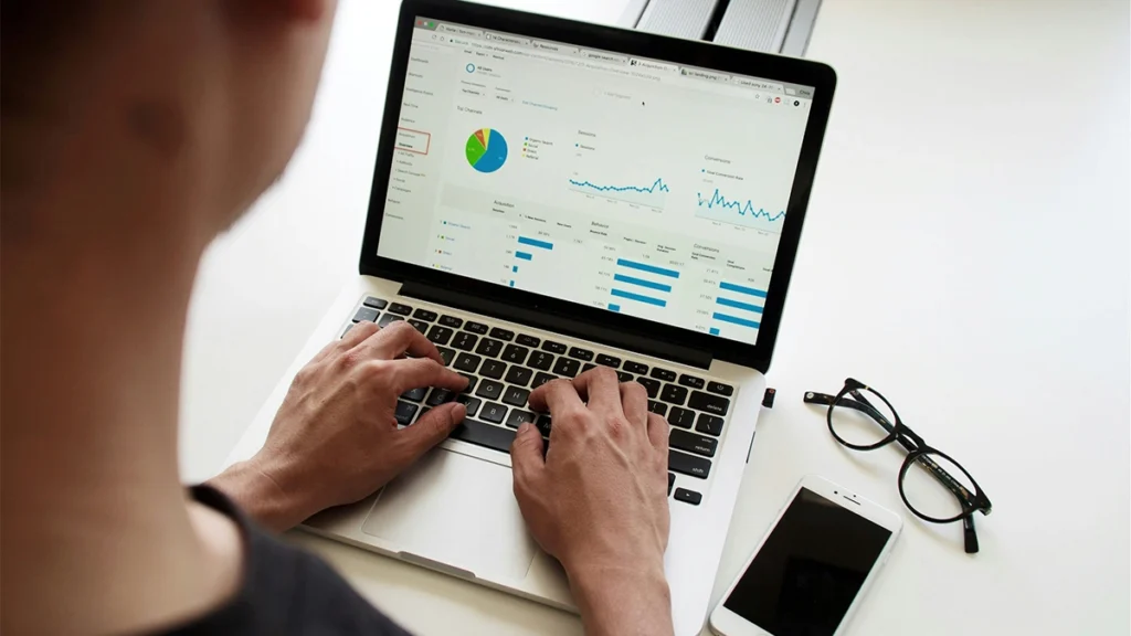 Man looking at Google Analytics on laptop