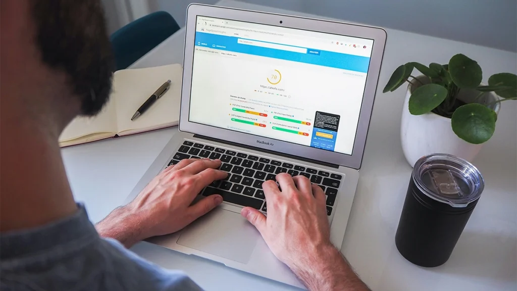 Man looking at website speed performance report on laptop