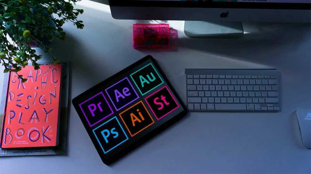 Desk with tablet displaying all the Adobe icons