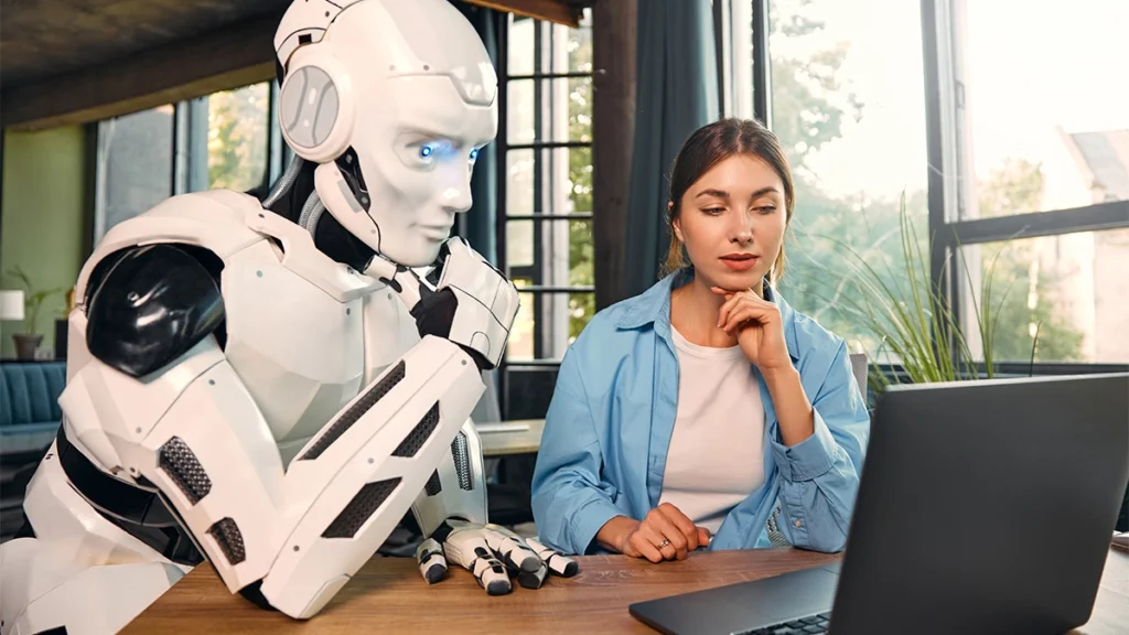 Lady working with a robot at a computer