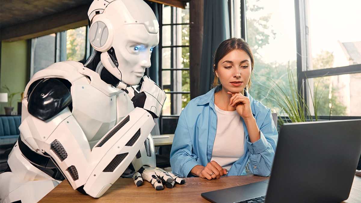 Lady working with a robot at a computer