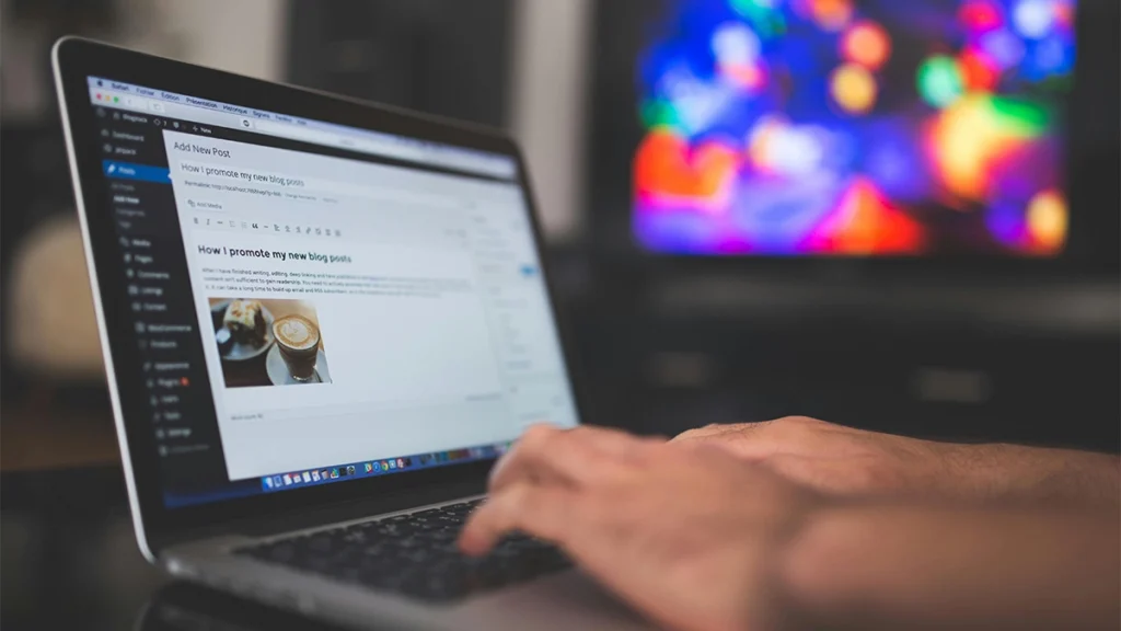 Man writing a blog post on a laptop