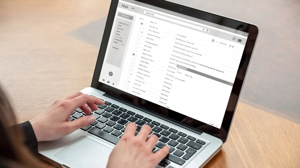 Man writing and email on laptop