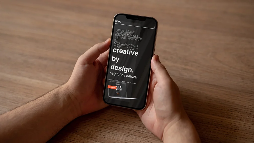 Man holding a phone with an example of a broken website