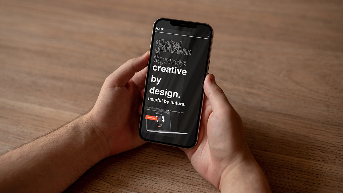 Man holding a phone with an example of a broken website