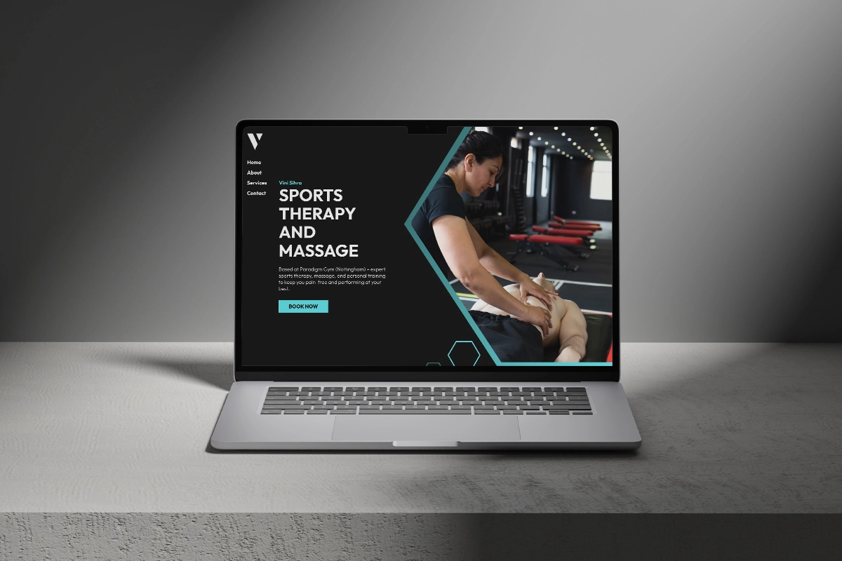 Laptop sitting on concrete slab with a mockup of the Vinify Therapy website