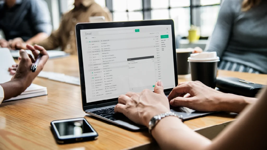 Woman checking her email in a meeting
