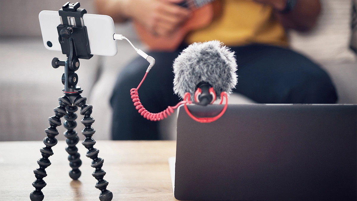 Laptop phone and music influencer man with ukule