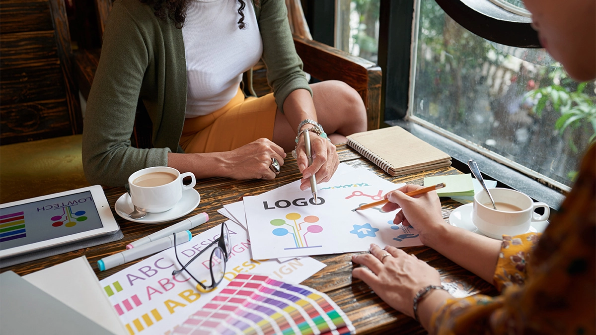 Graphic designer working with client on logo design