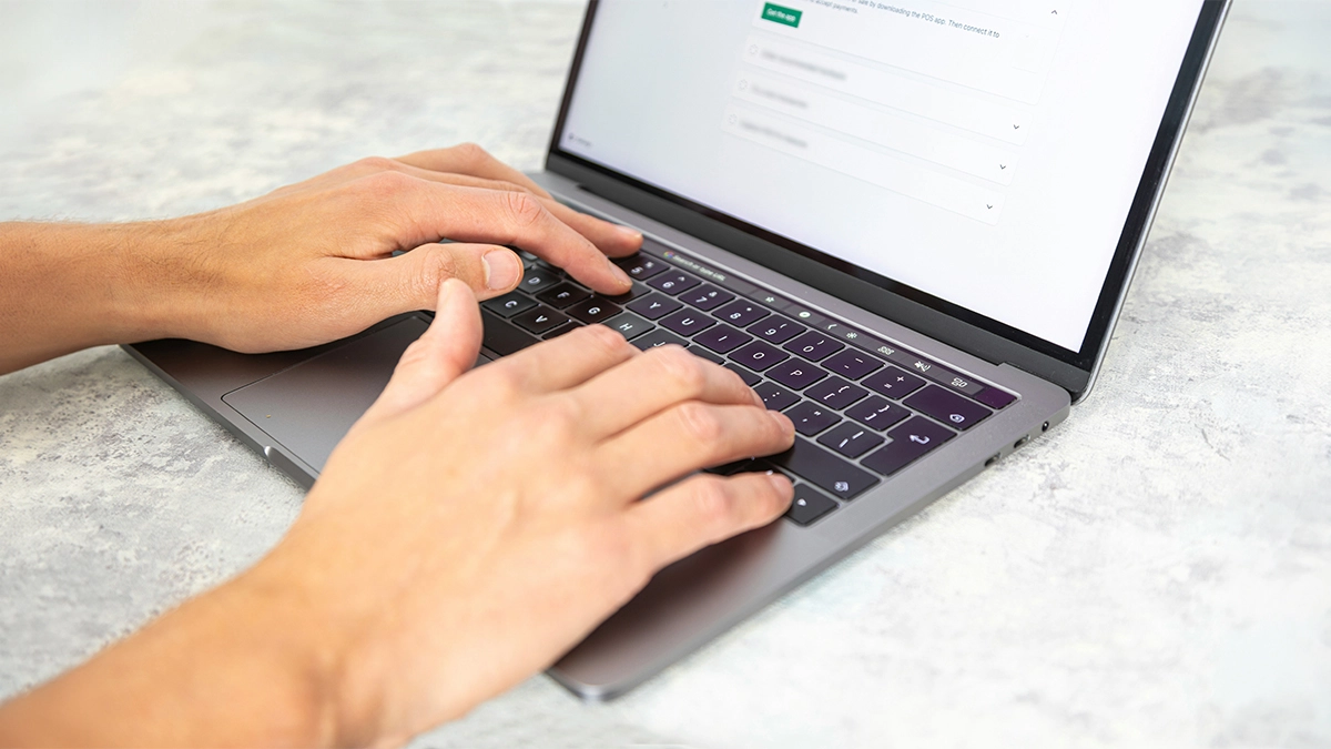 Man working and typing on laptop