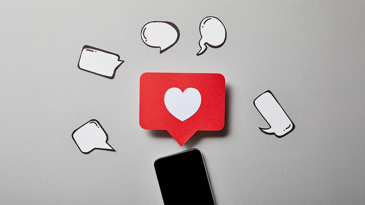 Red heart on phone with speech bubbles