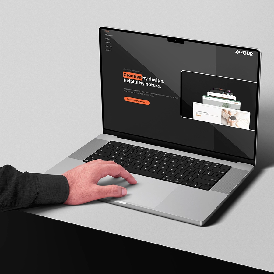 Hand using laptop with 404 Marketing website