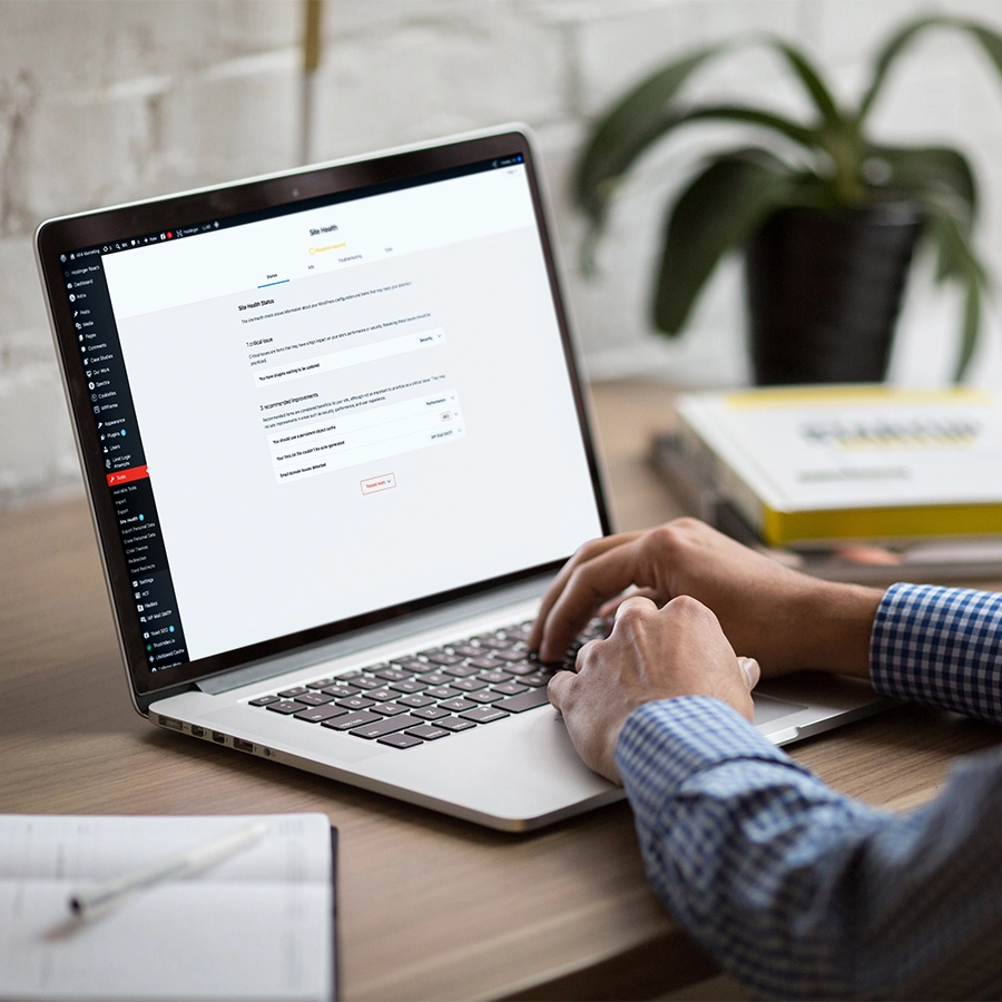 Man looking at the WordPress health screen on laptop