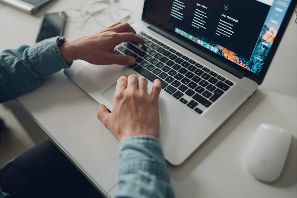 Man using a Macbook for digital marketing