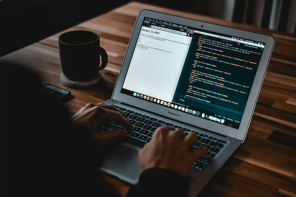 Web developer looking at website code during maintenance