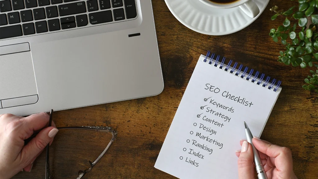 An SEO checklist on a table with laptop and coffee