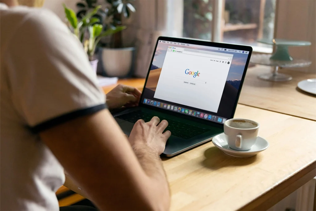 Man using Google search on a laptop