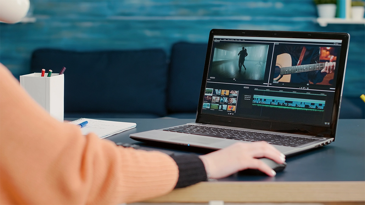 Person editing a video on a laptop