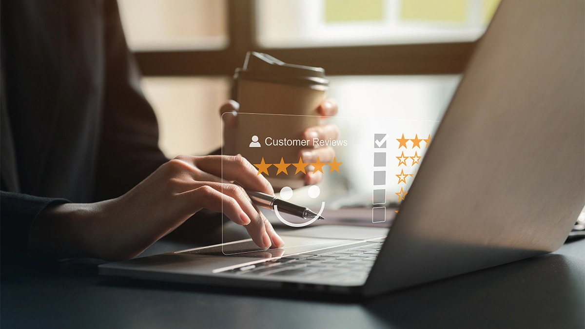 Woman looking at Google reviews on laptop