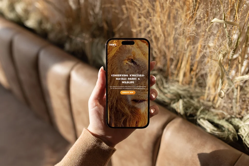 Woman holding phone with PAWZ Africa website