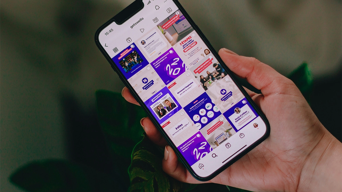 Person holding a phone with Instagram grid